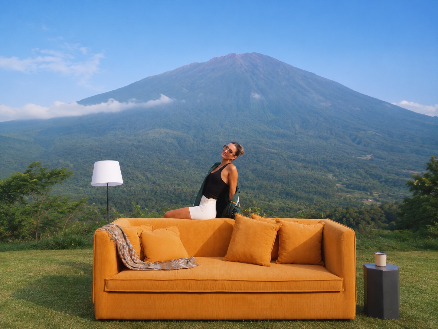 Mariah Brunner seated on an orange sofa in front of a mountain